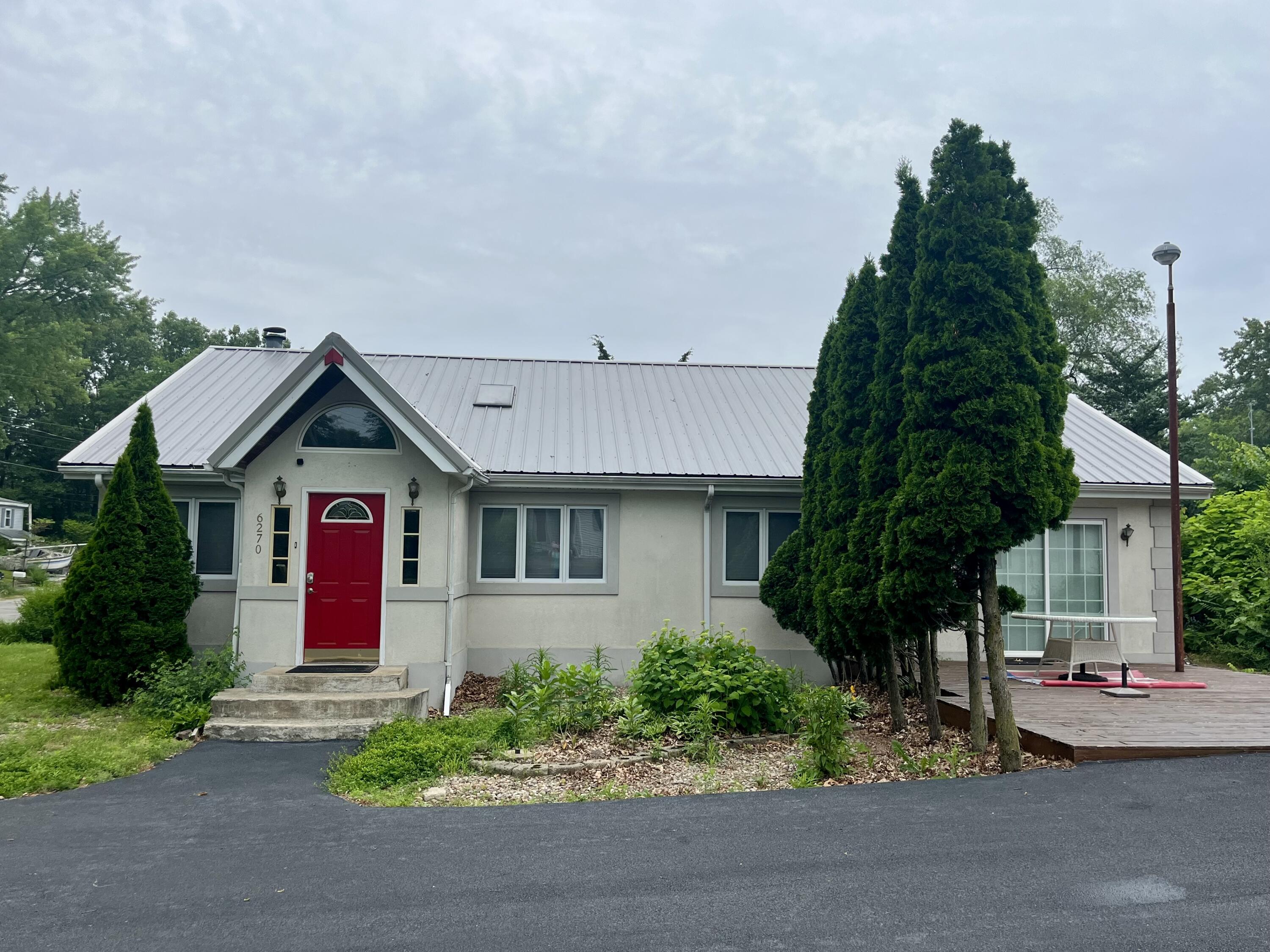 6270 East Donald Road Knox, IN 46534 - Photo 1 of 26 a front view of a house with a yard and garage