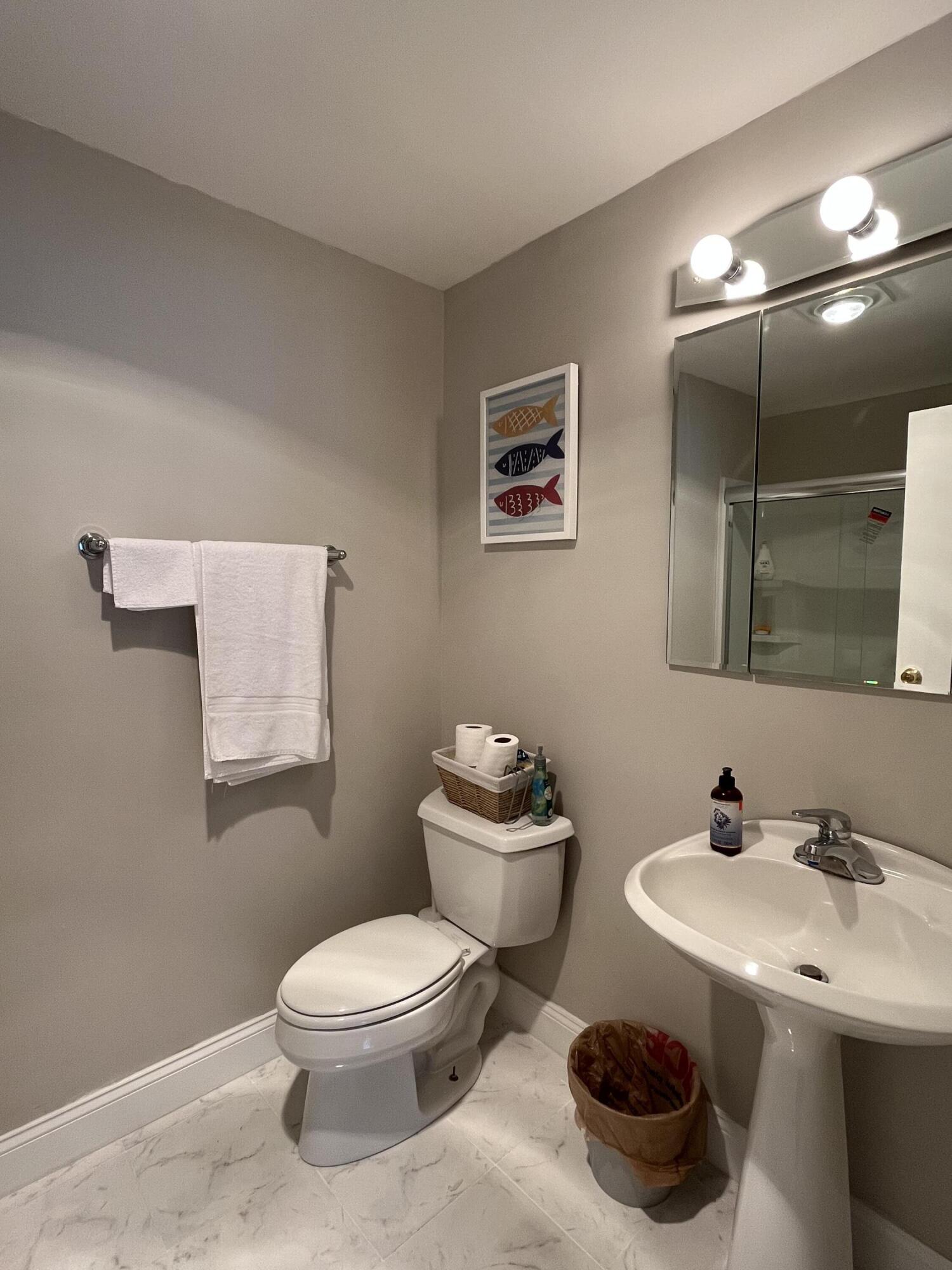 6270 East Donald Road Knox, IN 46534 - Photo 21 of 26 a bathroom with a toilet a sink and mirror