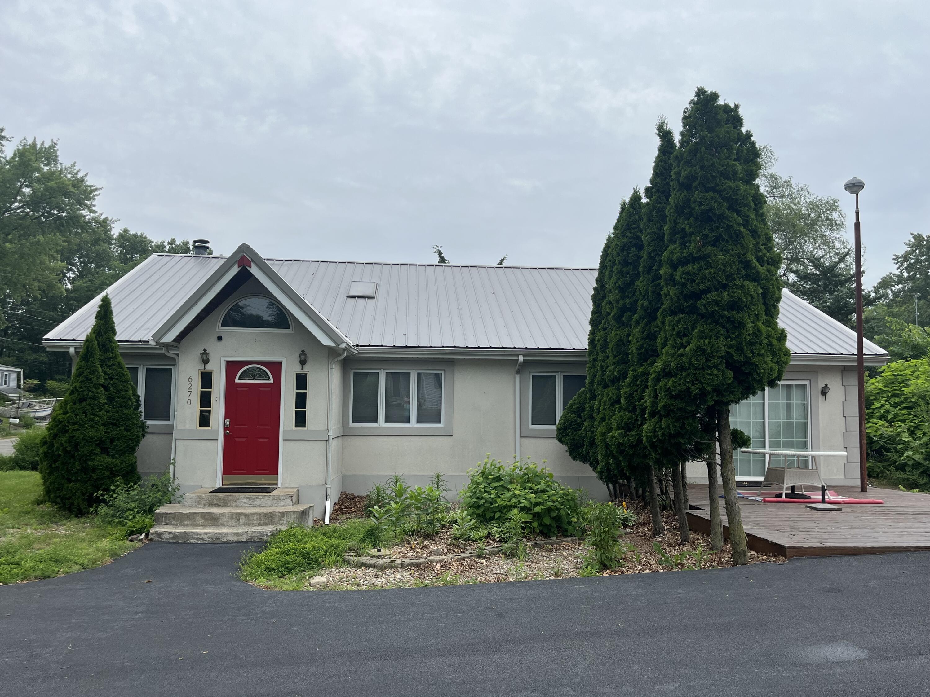 6270 East Donald Road Knox, IN 46534 - Photo 5 of 26 a front view of a house with a yard and garage