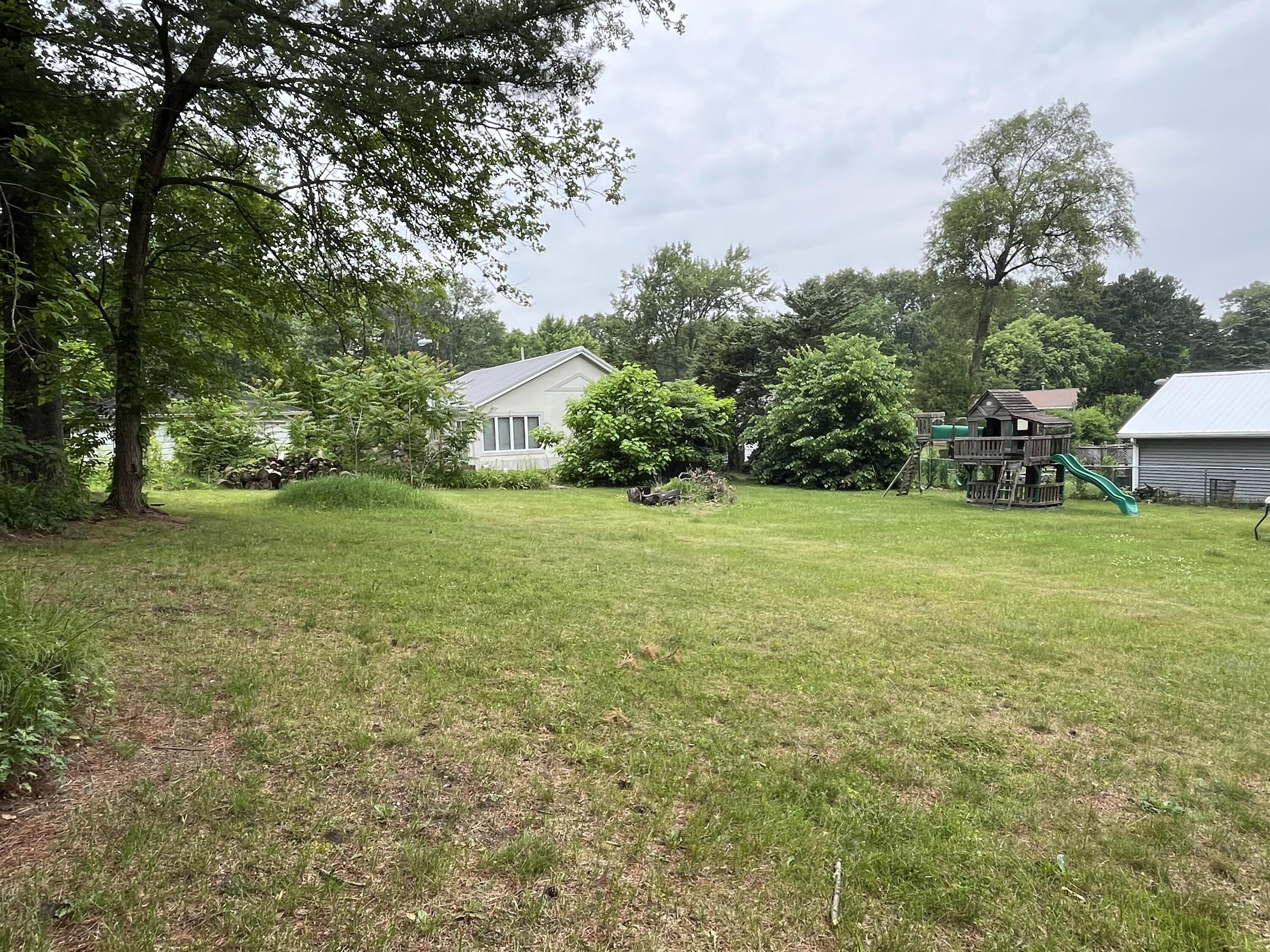 6270 East Donald Road Knox, IN 46534 - Photo 7 of 26 a view of a green field with trees in the background