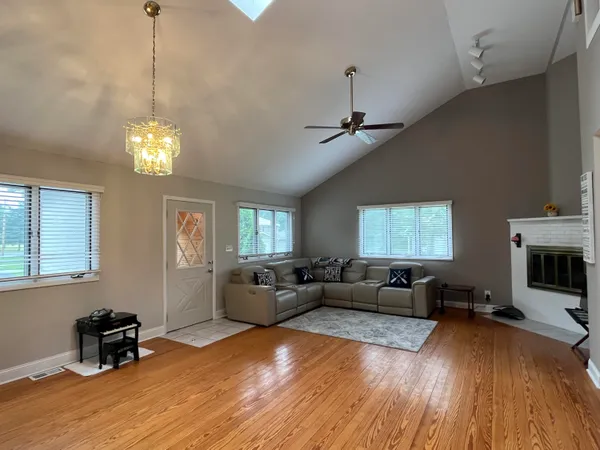 a living room with furniture a fireplace and a flat screen tv