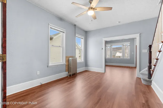 wooden floor in an empty room with a window