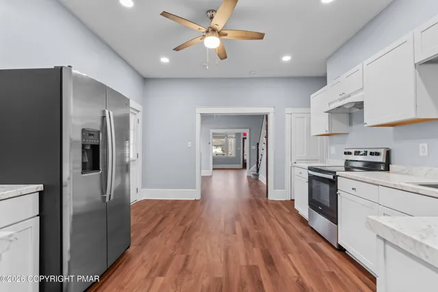 a kitchen with stainless steel appliances a refrigerator sink and stove