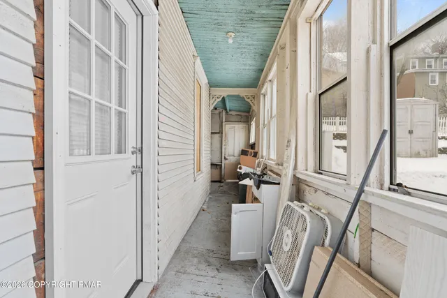 a view of white house with a snow in the yard