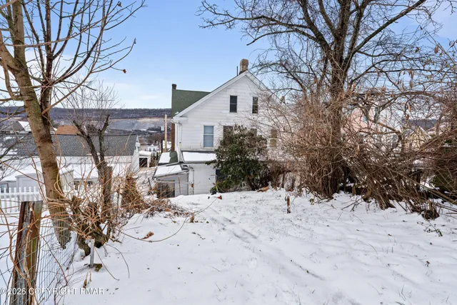 a view of snow on the side of a road