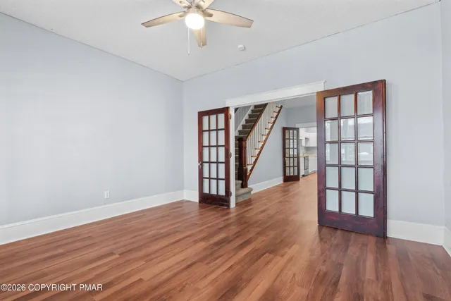 wooden floor in an empty room with a window