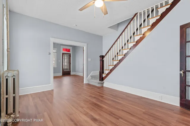 a view of an entryway with wooden floor