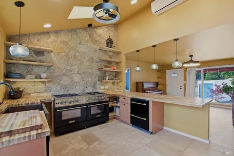 a kitchen with stainless steel appliances granite countertop a stove and a sink