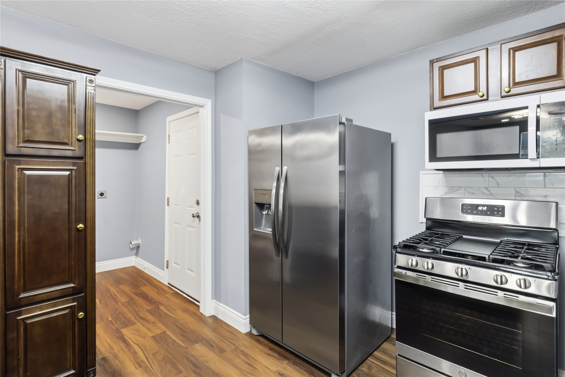 901 South 7th Street Baytown, TX 77520 - Photo 12 of 36 a kitchen with stainless steel appliances and refrigerator