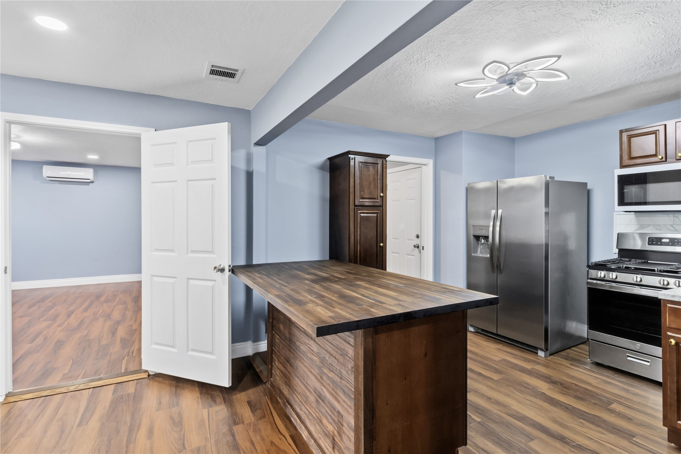901 South 7th Street Baytown, TX 77520 - Photo 15 of 36 a kitchen with stainless steel appliances granite countertop a refrigerator a sink a stove and island