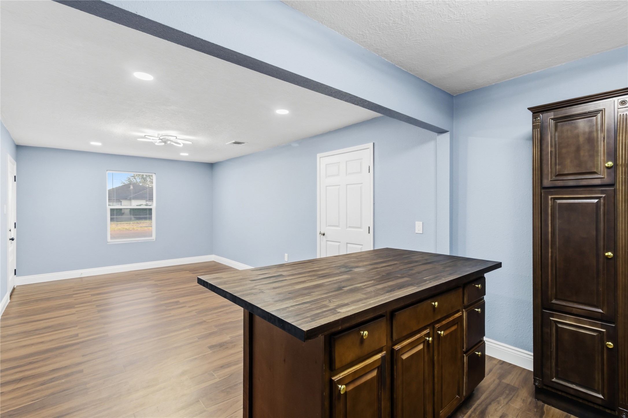901 South 7th Street Baytown, TX 77520 - Photo 17 of 36 a kitchen with a wooden floor and a refrigerator