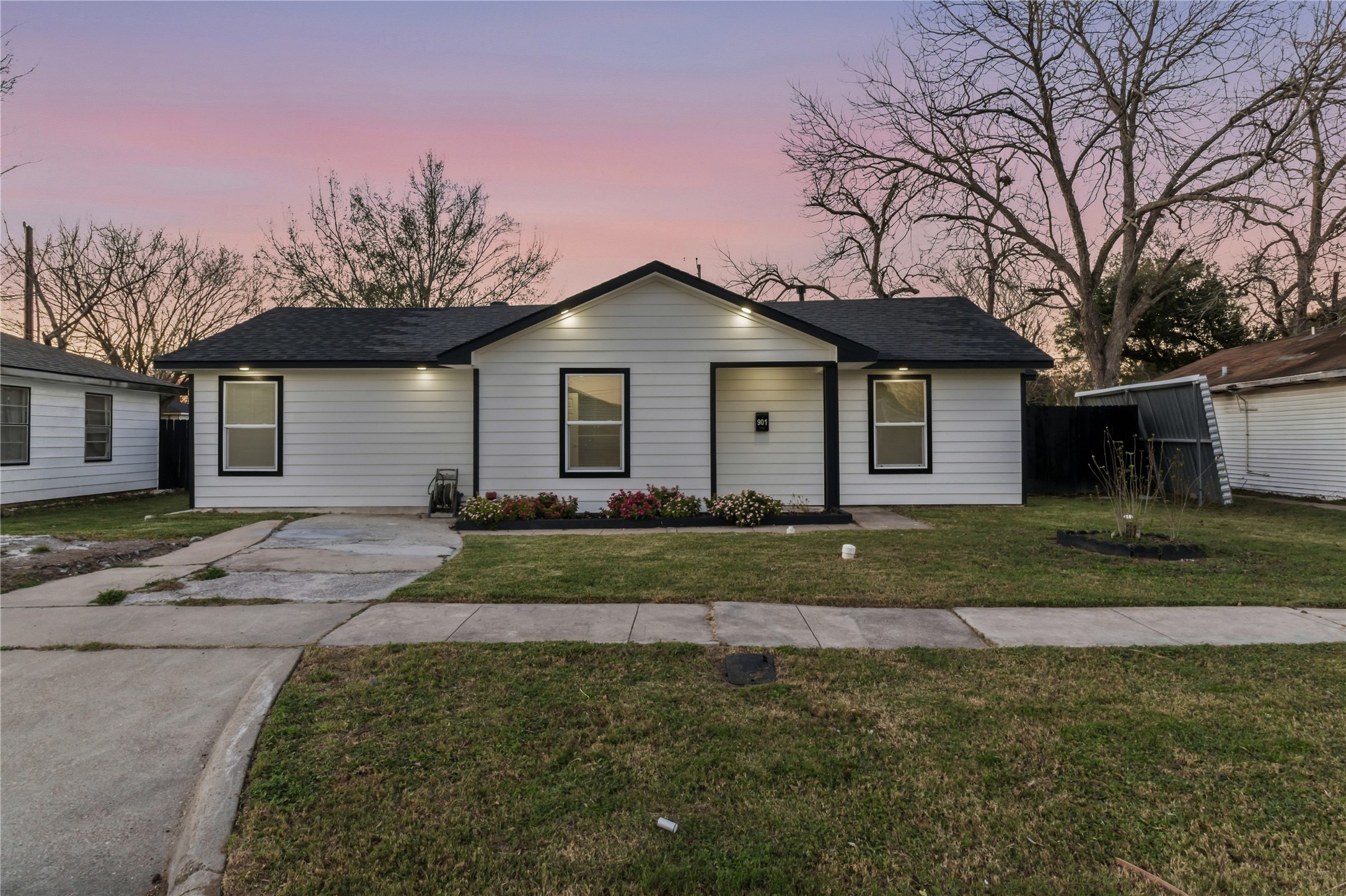 901 South 7th Street Baytown, TX 77520 - Photo 2 of 36 a front view of a house with a yard and garage
