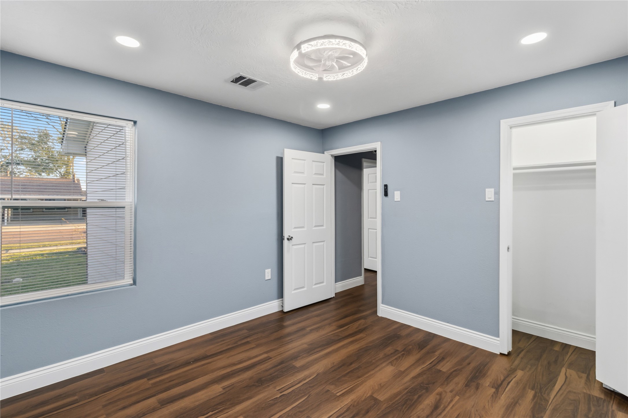 901 South 7th Street Baytown, TX 77520 - Photo 23 of 36 an empty room with wooden floor and windows