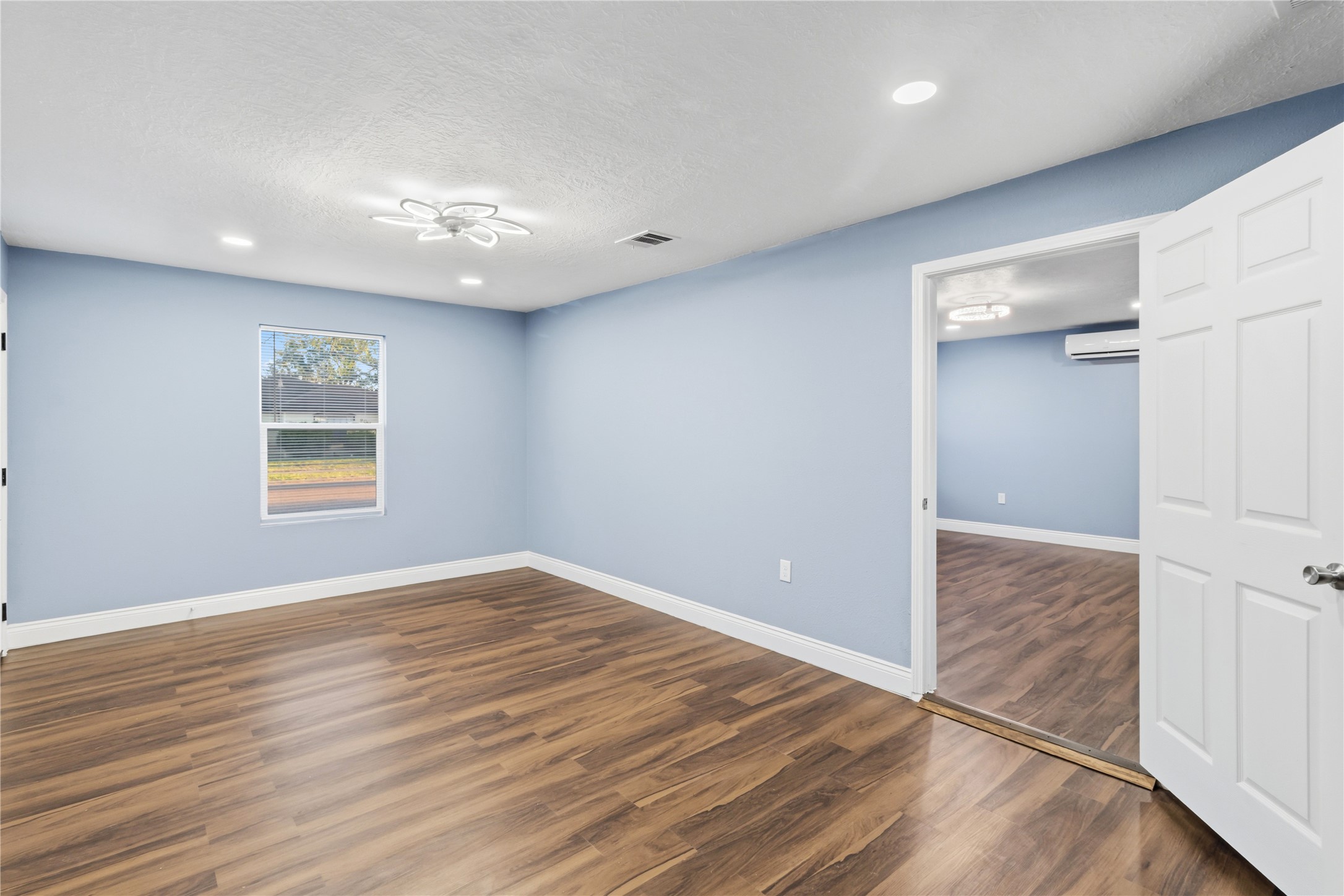 901 South 7th Street Baytown, TX 77520 - Photo 8 of 36 an empty room with wooden floor and windows