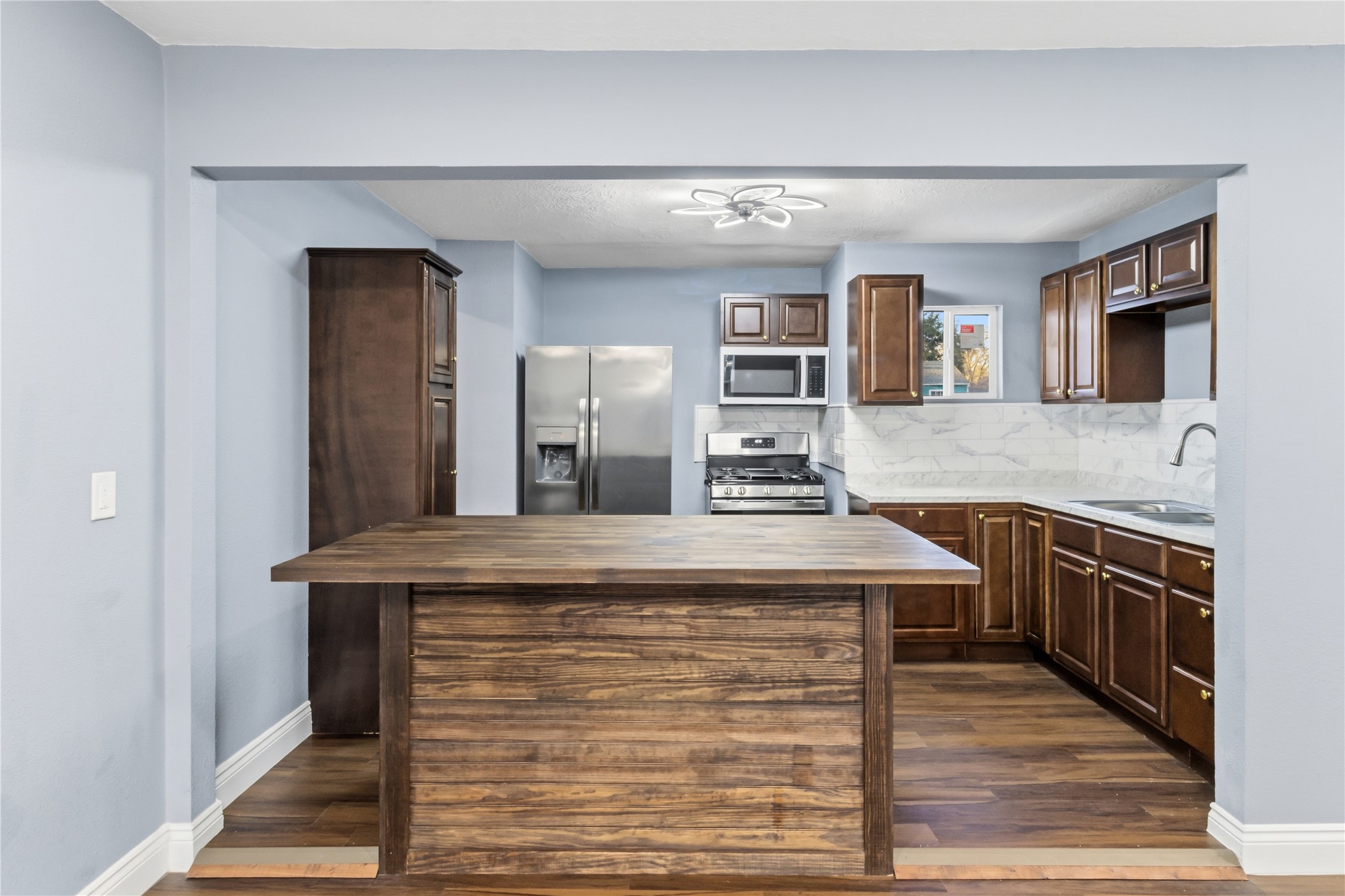 901 South 7th Street Baytown, TX 77520 - Photo 10 of 36 a kitchen with kitchen island a sink stainless steel appliances and cabinets