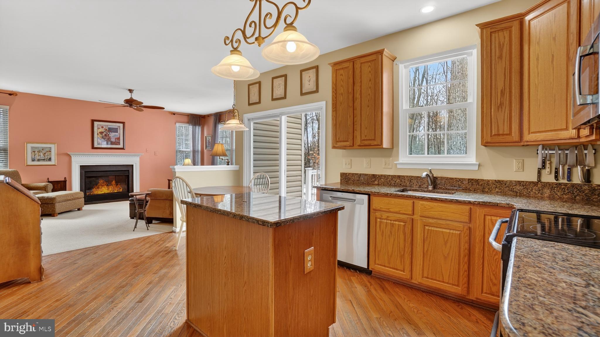 2806 Erna Court Crofton, MD 21054 - Photo 11 of 60 a kitchen with stainless steel appliances granite countertop a stove top oven a sink dishwasher and wooden cabinets with wooden floor