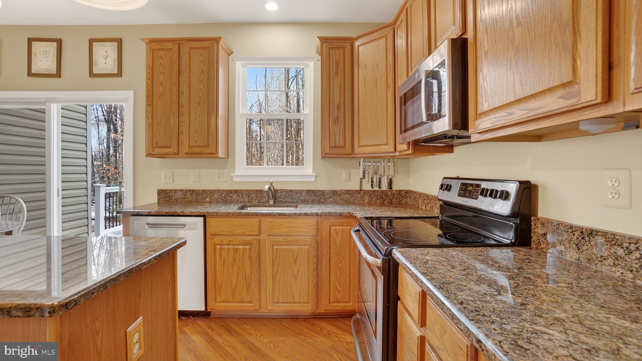 2806 Erna Court Crofton, MD 21054 - Photo 12 of 60 a kitchen with stainless steel appliances granite countertop a sink and a stove