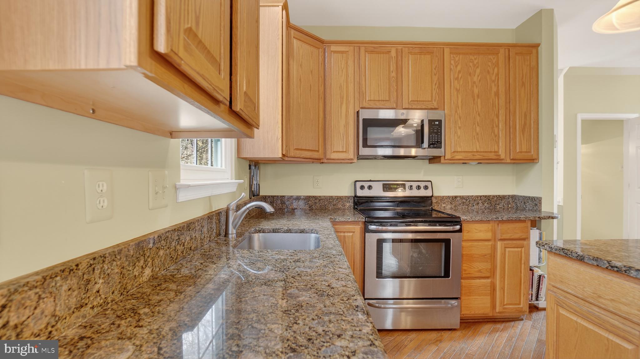2806 Erna Court Crofton, MD 21054 - Photo 13 of 60 a kitchen with granite countertop a stove and a sink