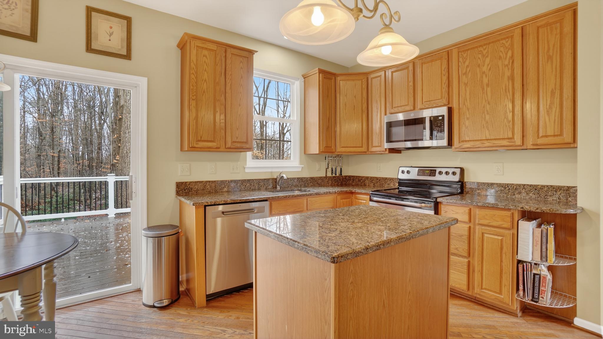 2806 Erna Court Crofton, MD 21054 - Photo 14 of 60 a kitchen with stainless steel appliances granite countertop a stove a sink and a microwave