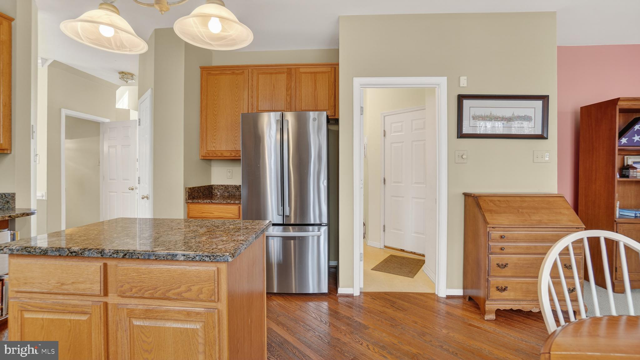 2806 Erna Court Crofton, MD 21054 - Photo 18 of 60 a kitchen with stainless steel appliances granite countertop a refrigerator and wooden floor
