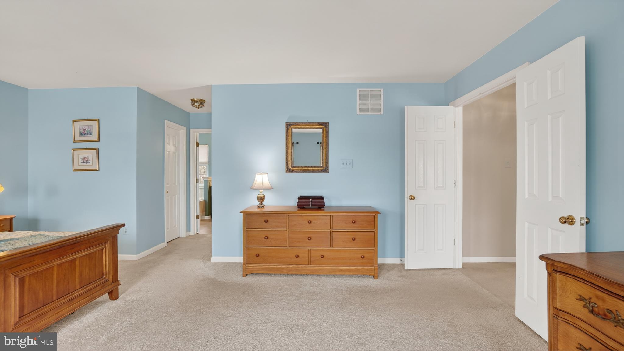 2806 Erna Court Crofton, MD 21054 - Photo 28 of 60 a spacious bedroom with a bed and cabinet