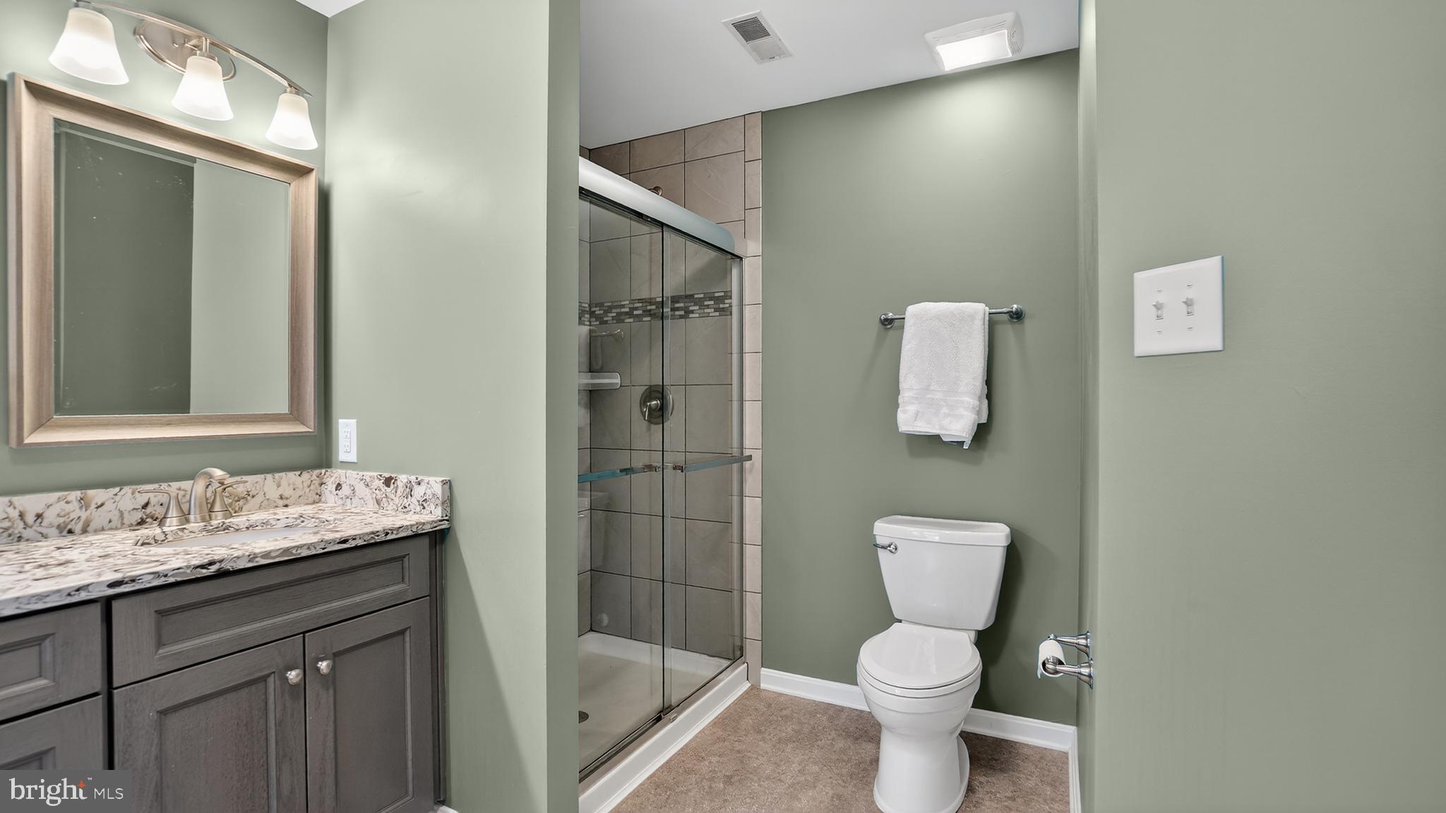 2806 Erna Court Crofton, MD 21054 - Photo 33 of 60 a bathroom with a granite countertop toilet sink and mirror