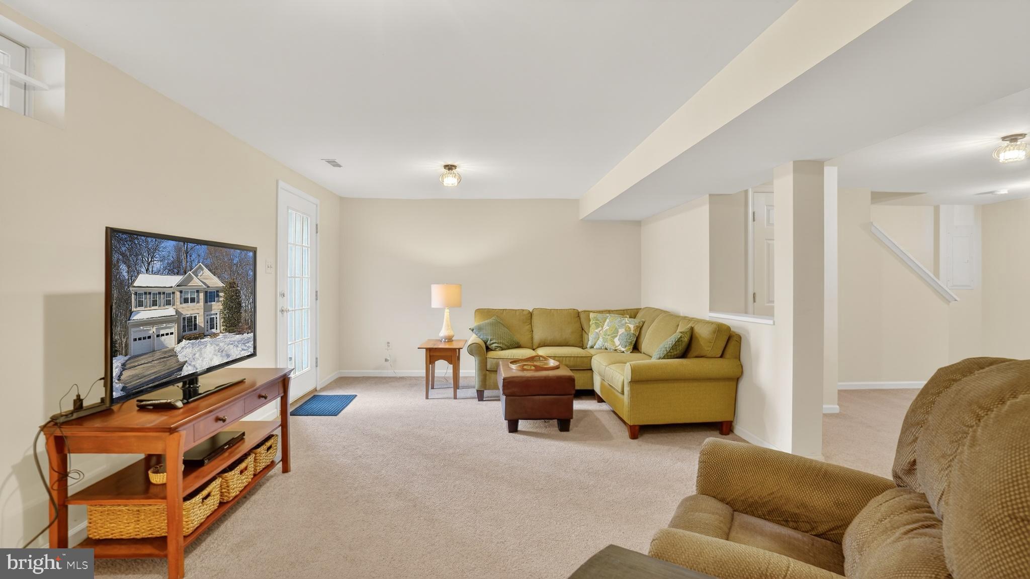 2806 Erna Court Crofton, MD 21054 - Photo 47 of 60 a living room with furniture and a flat screen tv