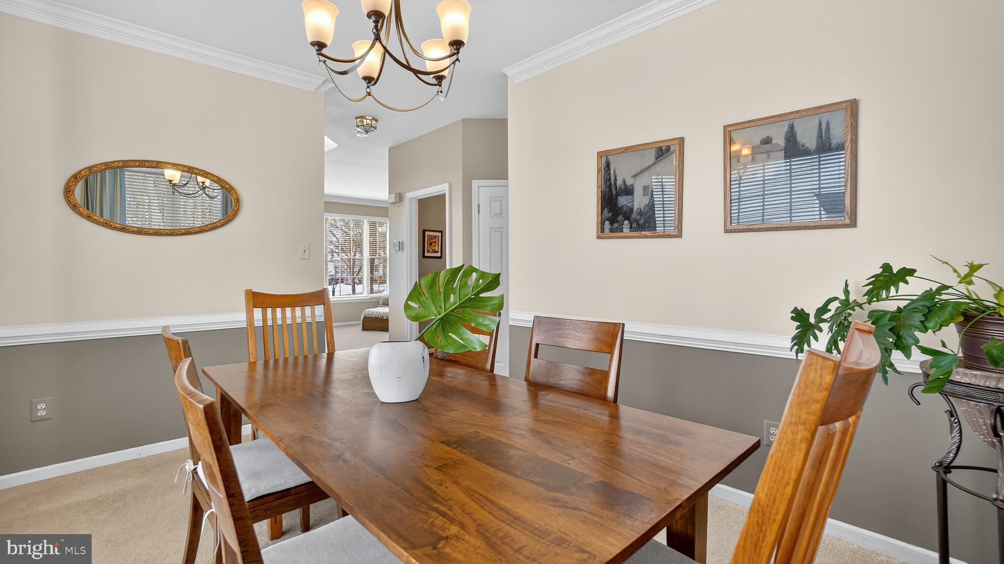 2806 Erna Court Crofton, MD 21054 - Photo 8 of 60 a view of a dining room with furniture a potted plant and wooden floor