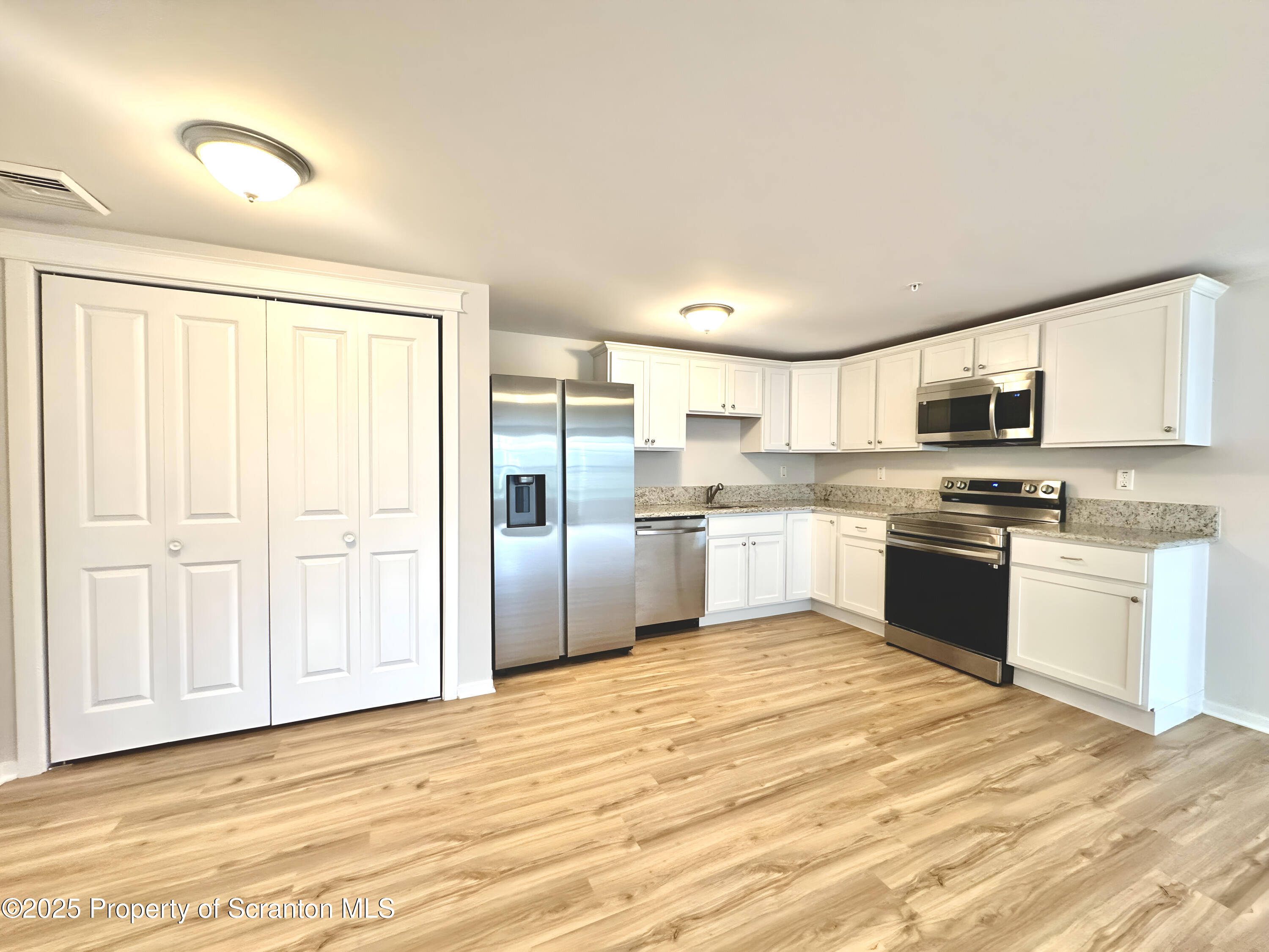 88 Bianca Way Old Forge, PA 18518 - Photo 3 of 10 a kitchen with granite countertop white cabinets and stainless steel appliances