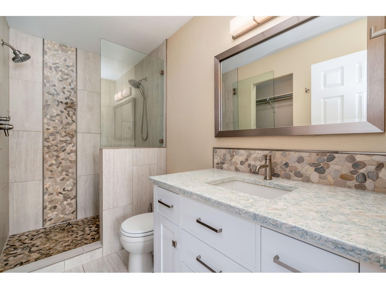 3779 Mount Meeker Street Wellington, CO 80549 - Photo 12 of 30 a bathroom with a granite countertop toilet sink and mirror