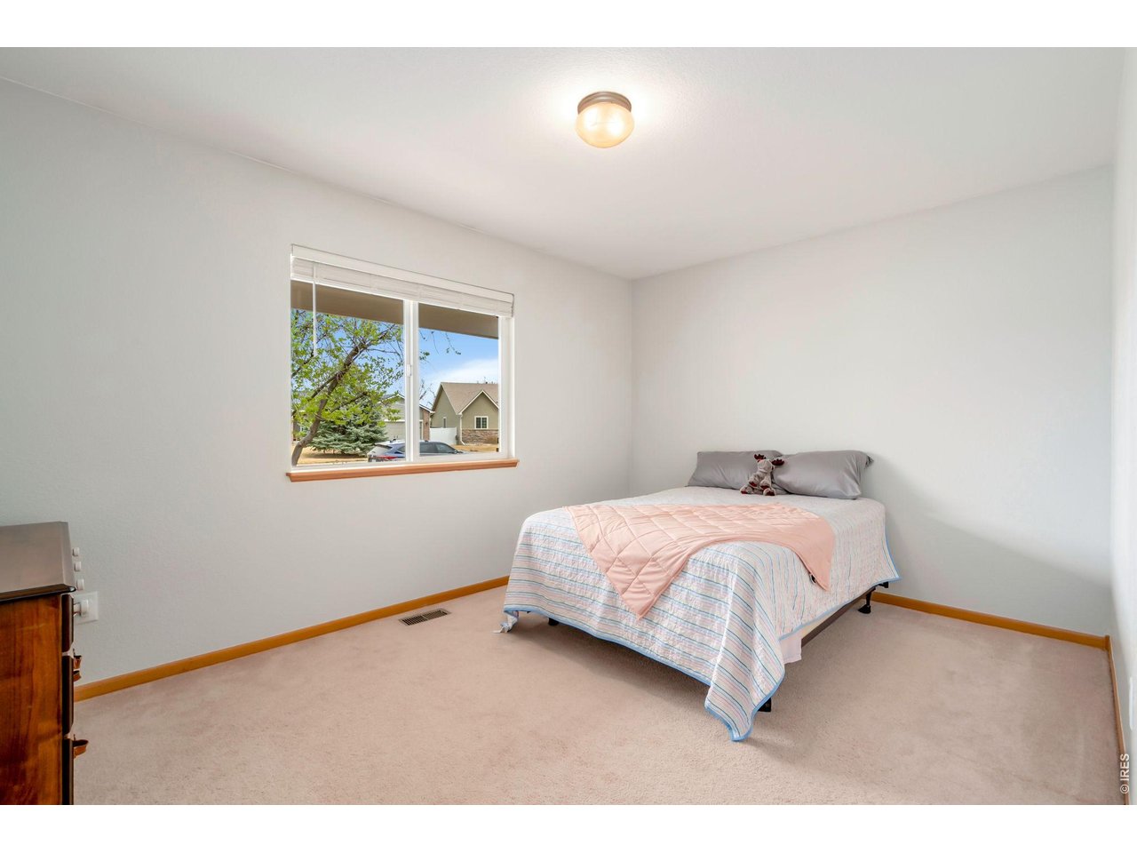 3779 Mount Meeker Street Wellington, CO 80549 - Photo 14 of 30 a bedroom with a bed and a painting on the wall