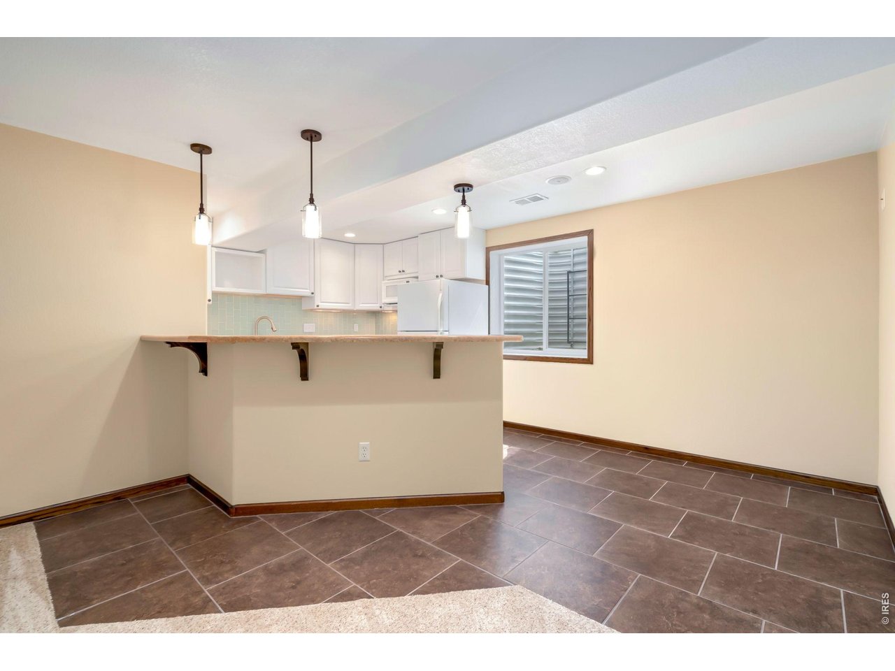 3779 Mount Meeker Street Wellington, CO 80549 - Photo 19 of 30 a view of kitchen with kitchen island microwave and stove