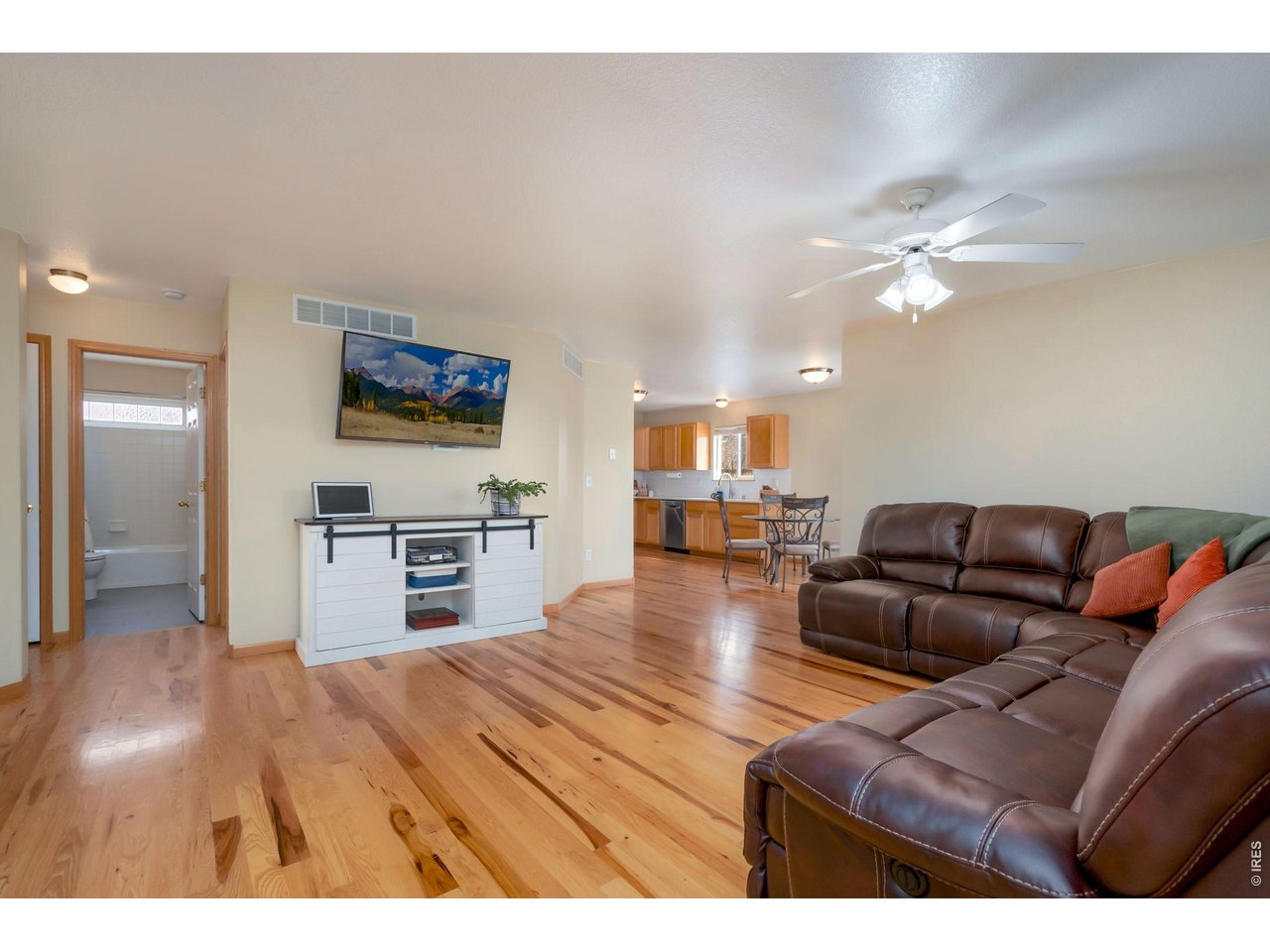 3779 Mount Meeker Street Wellington, CO 80549 - Photo 2 of 30 a living room with furniture and a flat screen tv