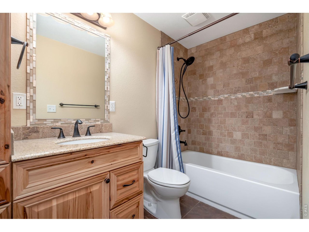 3779 Mount Meeker Street Wellington, CO 80549 - Photo 23 of 30 a bathroom with a granite countertop sink toilet and shower