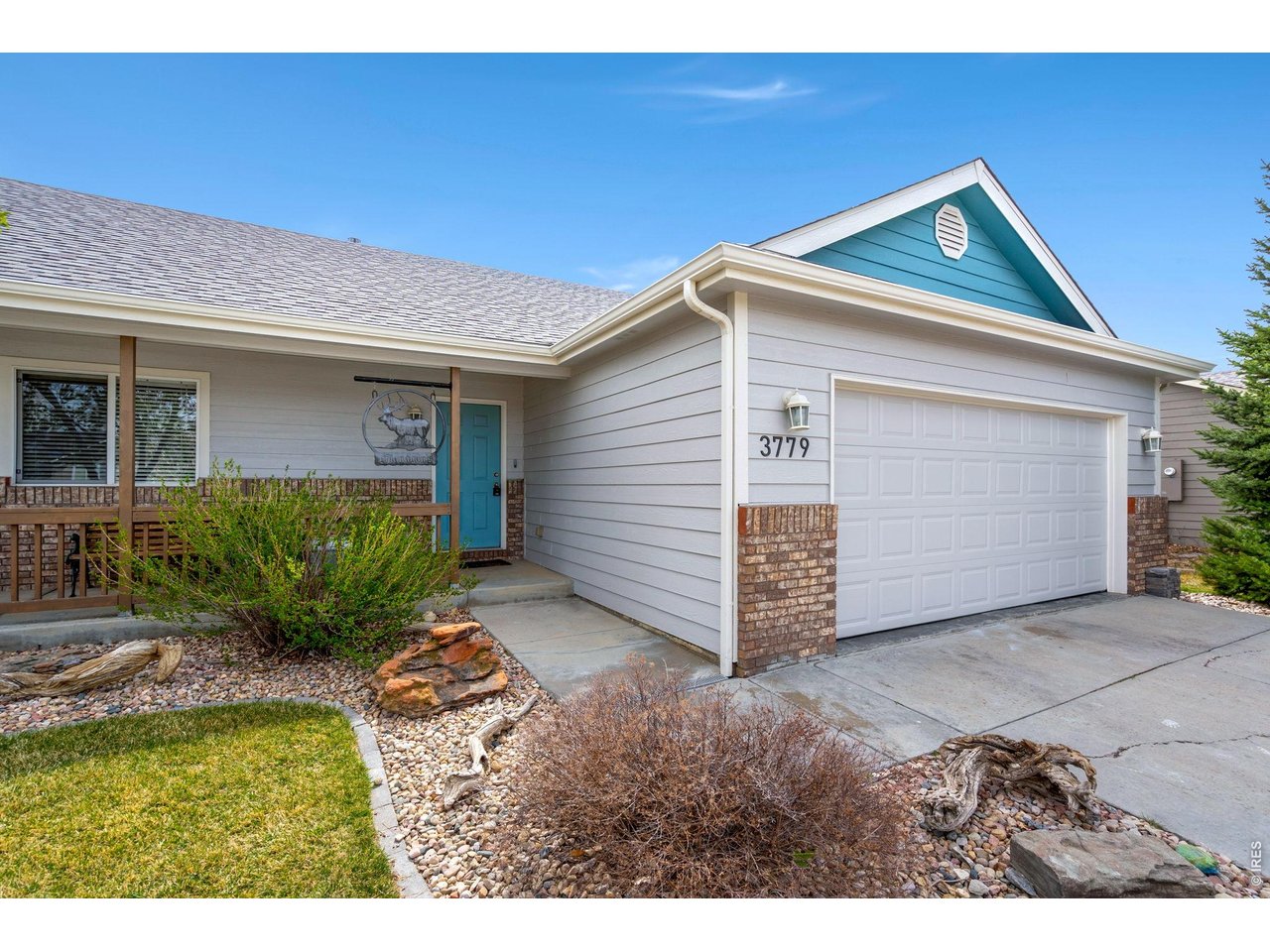 3779 Mount Meeker Street Wellington, CO 80549 - Photo 25 of 30 a front view of a house with garden