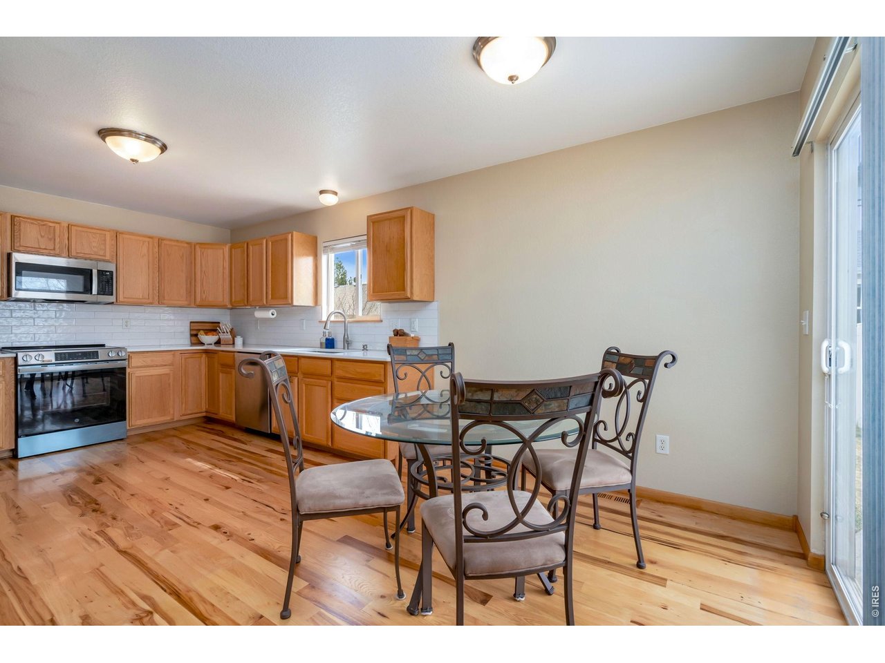 3779 Mount Meeker Street Wellington, CO 80549 - Photo 7 of 30 a kitchen with stainless steel appliances kitchen island granite countertop a sink and cabinets