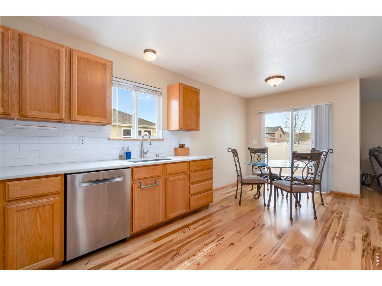 3779 Mount Meeker Street Wellington, CO 80549 - Photo 8 of 30 a kitchen with a table chairs and microwave