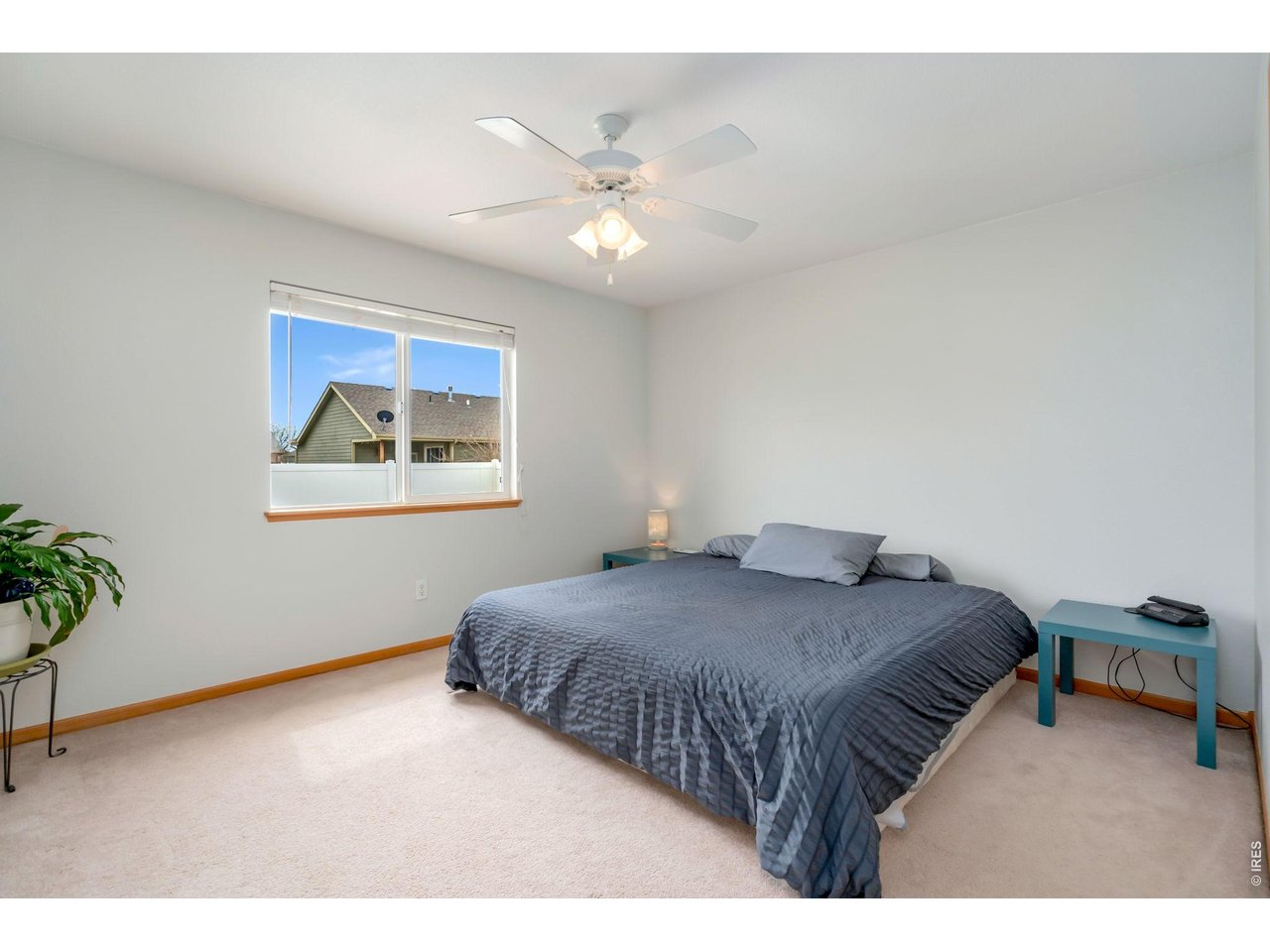 3779 Mount Meeker Street Wellington, CO 80549 - Photo 10 of 30 a bedroom with a large bed and a chandelier