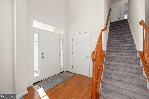 a view of entryway with wooden floor and stairs