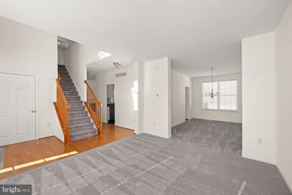 a view of an empty room with stairs and ventilation