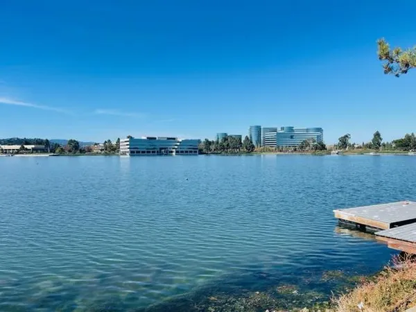 a view of a lake with houses in the back