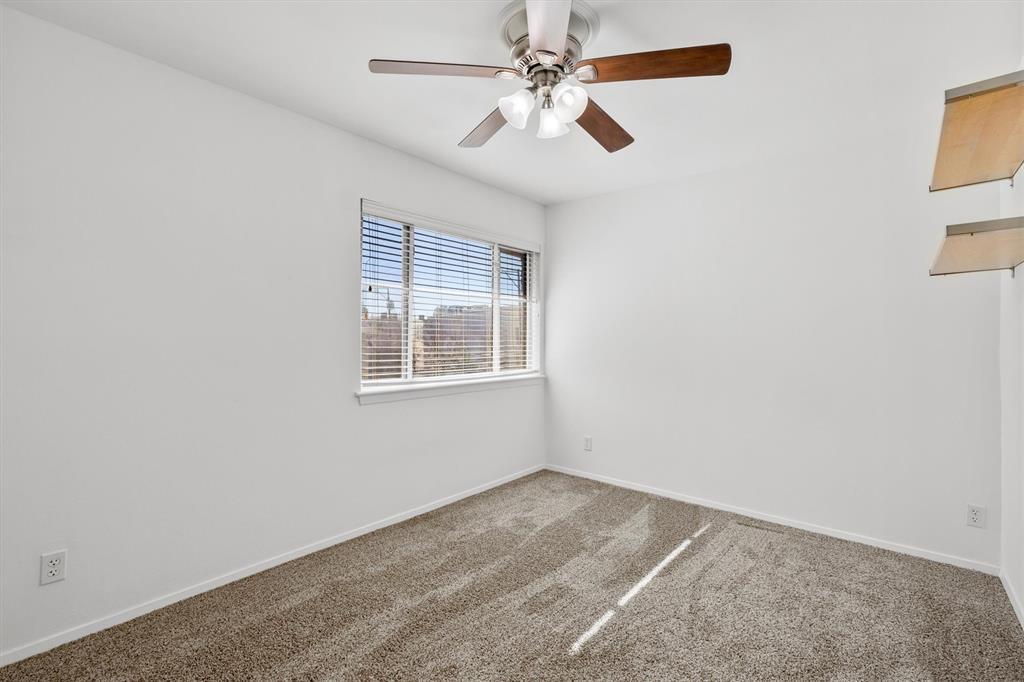 4039 Cole Avenue, Unit 105 Dallas, TX 75204 - Photo 18 of 39 Carpeted spare room featuring ceiling fan and baseboards