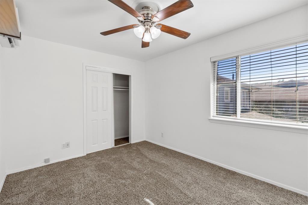 4039 Cole Avenue, Unit 105 Dallas, TX 75204 - Photo 19 of 39 Unfurnished bedroom with a ceiling fan, a closet, carpet flooring, and baseboards