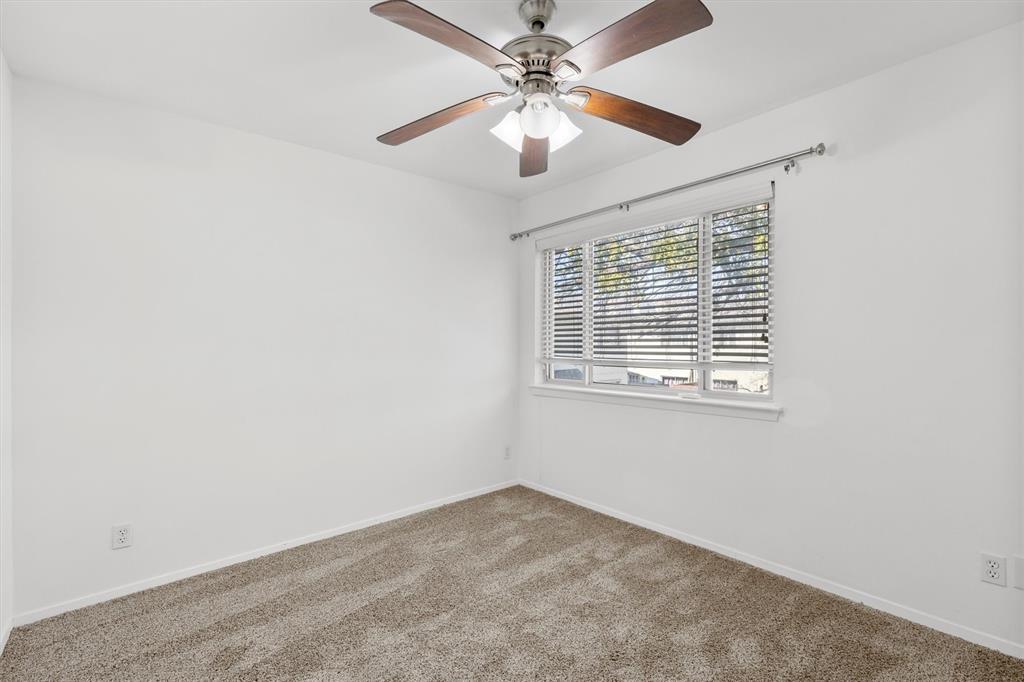 4039 Cole Avenue, Unit 105 Dallas, TX 75204 - Photo 22 of 39 Carpeted empty room with a ceiling fan and baseboards