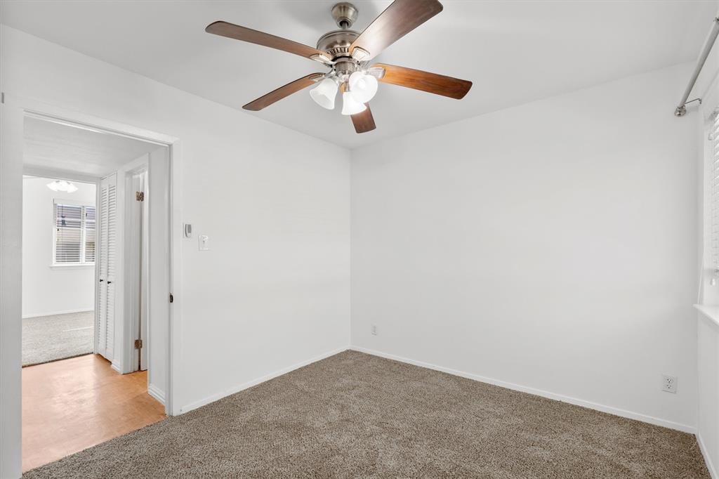 4039 Cole Avenue, Unit 105 Dallas, TX 75204 - Photo 25 of 39 Carpeted spare room featuring ceiling fan and baseboards