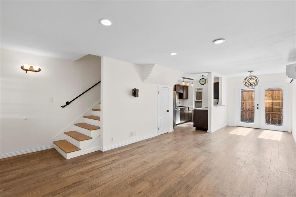 4039 Cole Avenue, Unit 105 Dallas, TX 75204 - Photo 6 of 39 Unfurnished living room with recessed lighting, wood finished floors, baseboards, french doors, and stairway