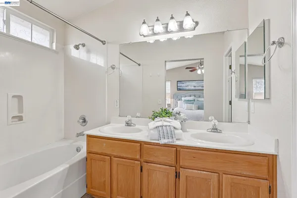 a bathroom with a double vanity sink and a bathtub