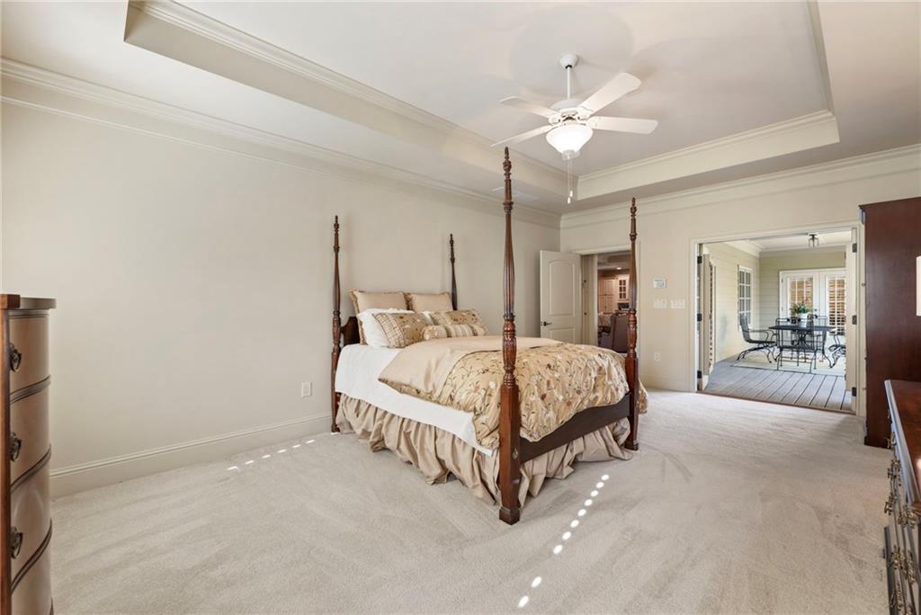 2472 Ballantrae Circle Cumming, GA 30041 - Photo 17 of 41 a spacious bedroom with a bed and a chandelier