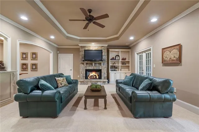 a living room with fireplace furniture and a large window