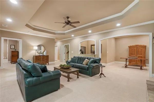 a living room with furniture and a ceiling fan